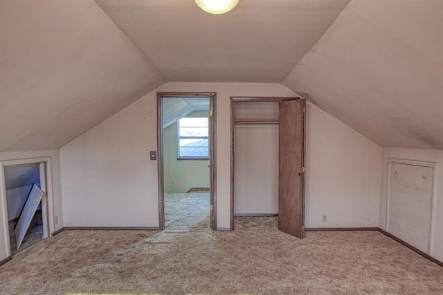 additional living space with lofted ceiling and light carpet