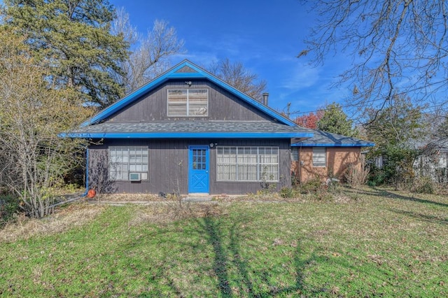 rear view of house with cooling unit and a yard