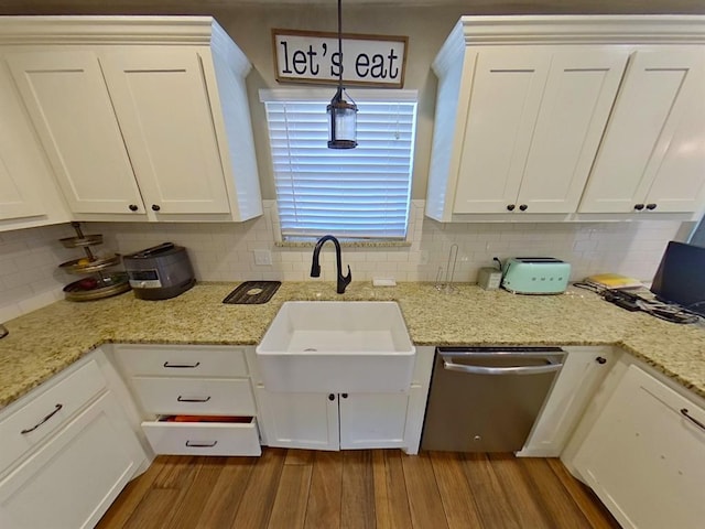 kitchen with decorative light fixtures, white cabinets, and stainless steel dishwasher