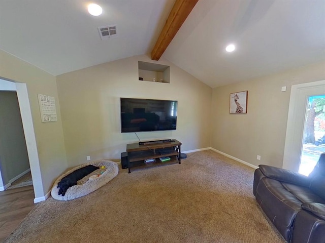 living room with lofted ceiling with beams and carpet flooring