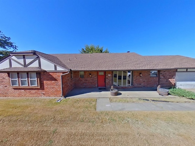 view of front of property with a garage and a front lawn