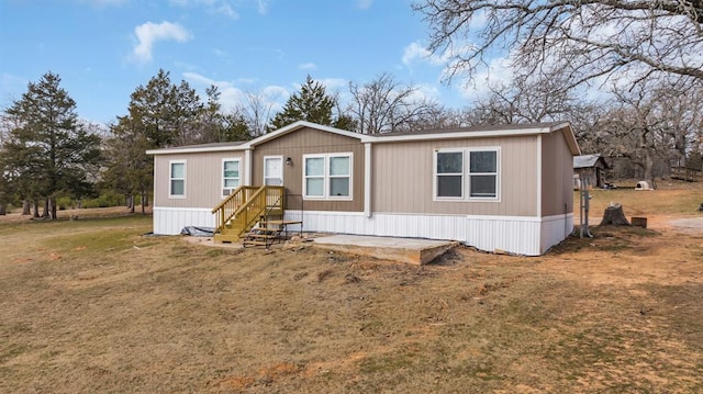 rear view of property with a yard