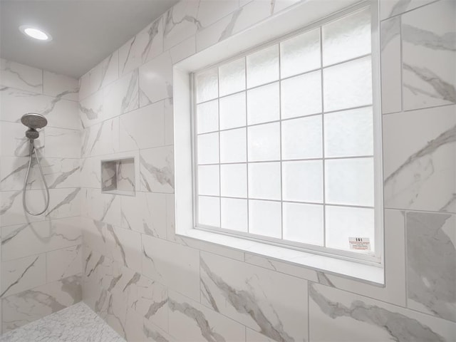 bathroom with a tile shower