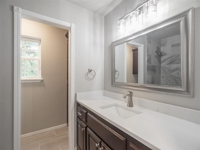 bathroom featuring walk in shower and vanity