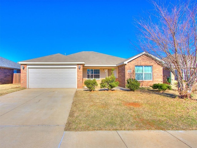 ranch-style house featuring a front lawn and a garage