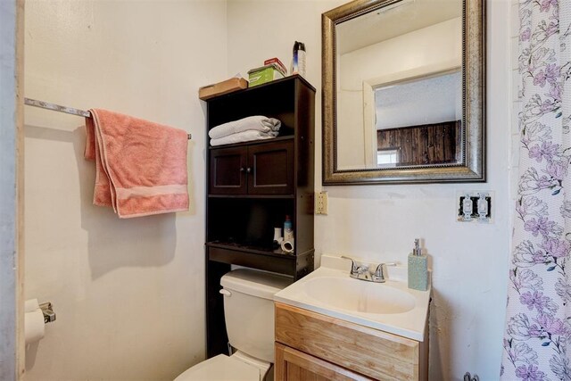 bathroom with toilet and vanity