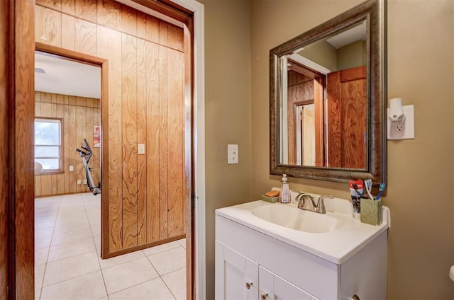 bathroom featuring tile patterned floors, wood walls, and vanity