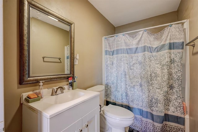 bathroom featuring toilet, vanity, and a shower with shower curtain