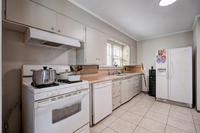 kitchen with white appliances, white cabinetry, sink, ornamental molding, and light tile patterned flooring