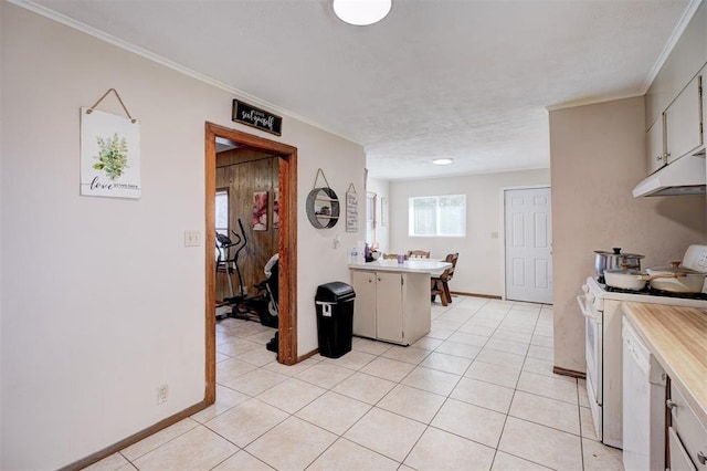 kitchen with light tile patterned floors, white stove, white cabinetry, and kitchen peninsula