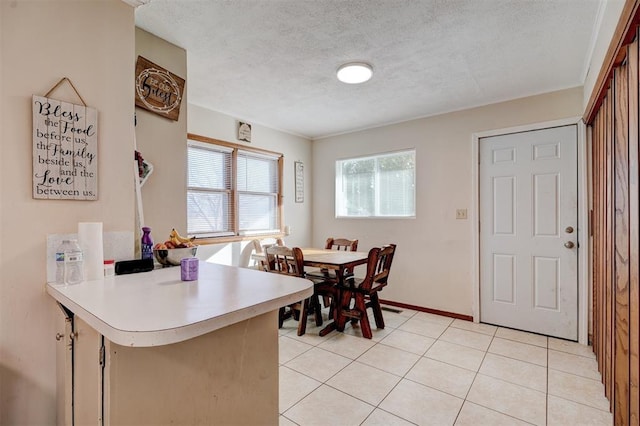 kitchen with light tile patterned floors and a textured ceiling