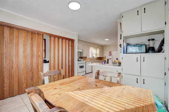 tiled dining room featuring ornamental molding