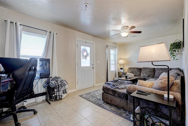 living room with ceiling fan and light tile patterned flooring