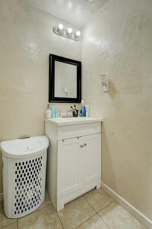 bathroom featuring a tub, tile patterned floors, and vanity