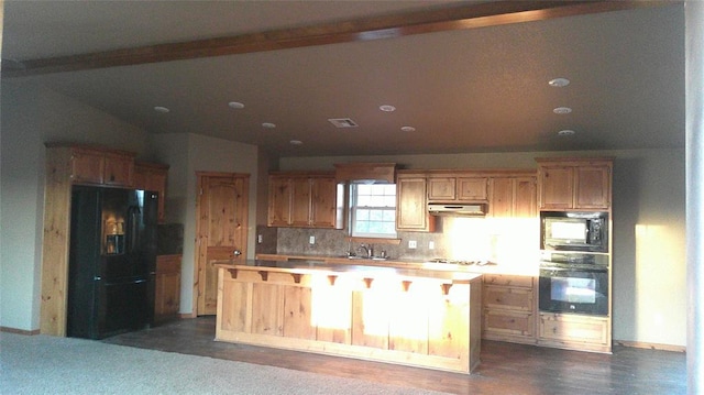 kitchen featuring black appliances, a kitchen island, sink, backsplash, and lofted ceiling with beams