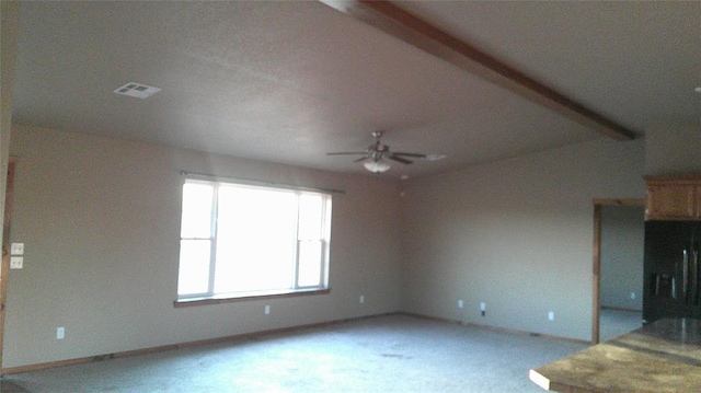 unfurnished living room featuring carpet floors and ceiling fan