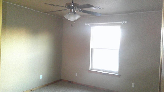 unfurnished room with ceiling fan and carpet flooring