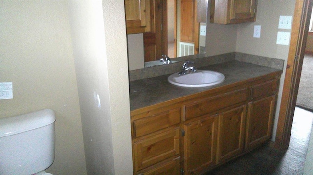 bathroom with toilet and vanity