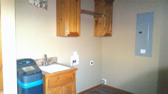 washroom featuring electric panel, sink, washer hookup, hookup for an electric dryer, and cabinets