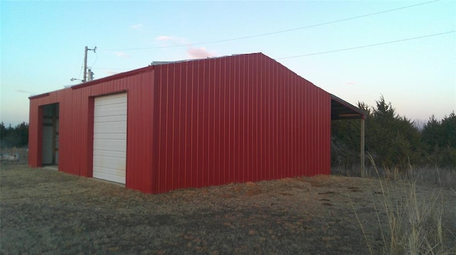 outdoor structure at dusk featuring a garage