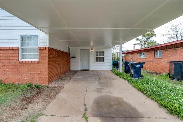 doorway to property featuring a carport