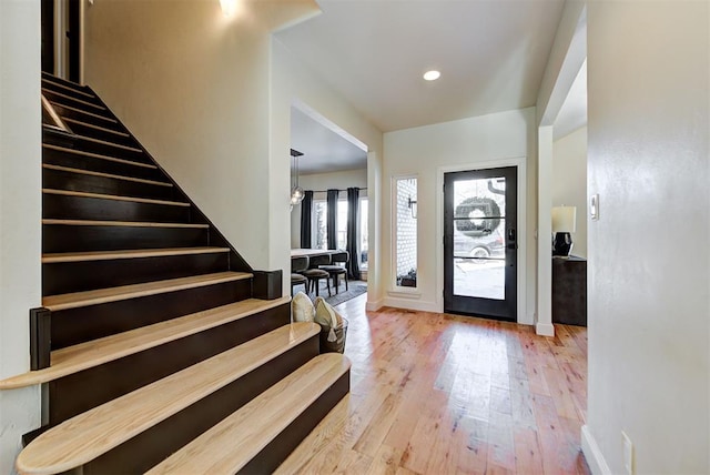 foyer with a chandelier and light wood-type flooring