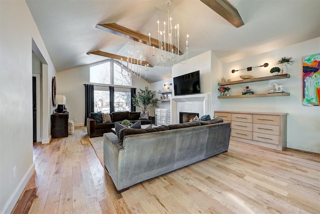 living room featuring vaulted ceiling with beams, a notable chandelier, and light hardwood / wood-style flooring