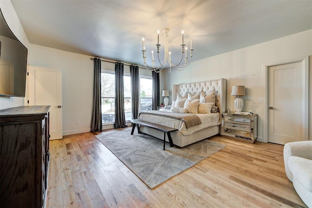 bedroom featuring light hardwood / wood-style flooring and a notable chandelier