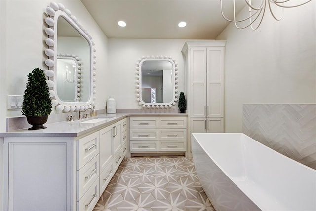 bathroom with tile patterned floors, vanity, and a bath