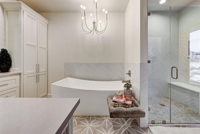 bathroom with vanity, a notable chandelier, and separate shower and tub