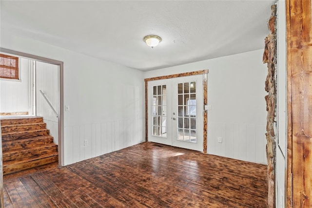 empty room featuring hardwood / wood-style flooring and french doors