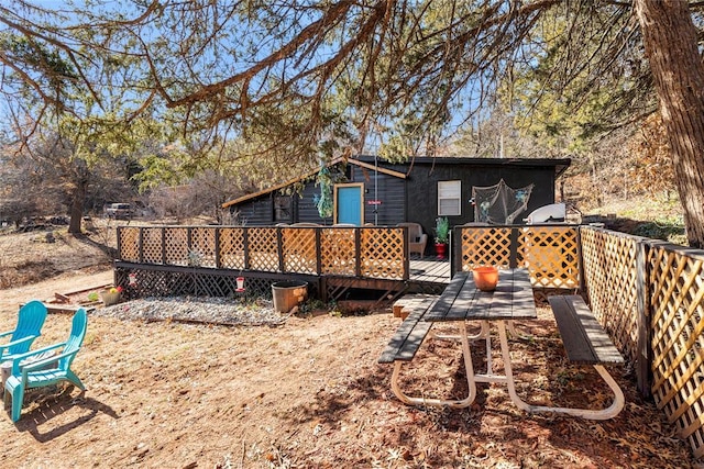 back of house featuring a wooden deck