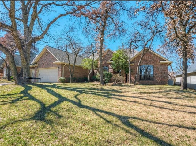 ranch-style house featuring a garage and a front yard