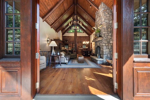 interior space with wood ceiling, hardwood / wood-style floors, beam ceiling, high vaulted ceiling, and a chandelier