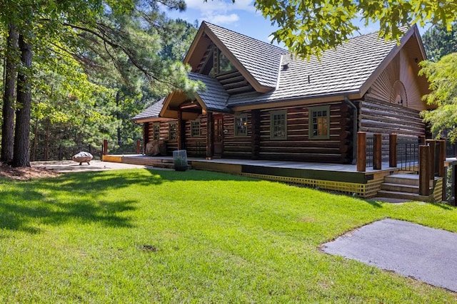 rear view of property featuring a yard