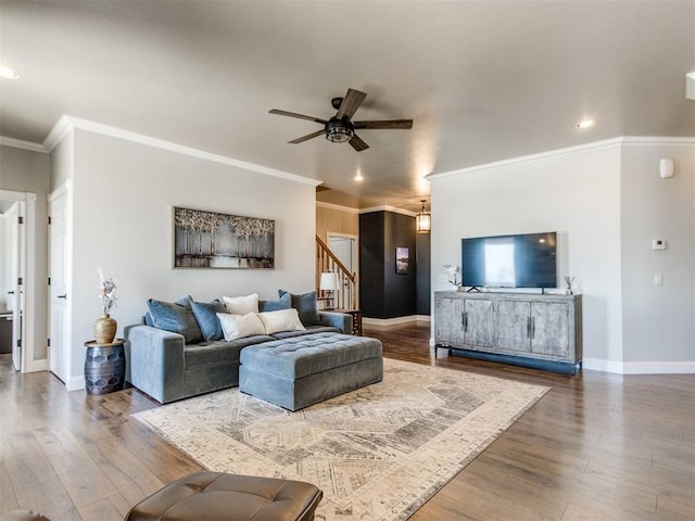 living room with hardwood / wood-style floors, ceiling fan, and ornamental molding