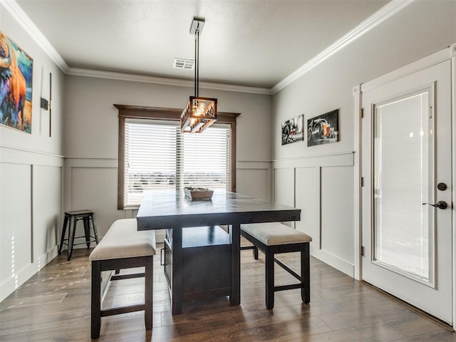 dining space featuring dark hardwood / wood-style floors and ornamental molding