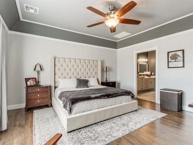 bedroom with ceiling fan, ensuite bathroom, dark hardwood / wood-style floors, and crown molding