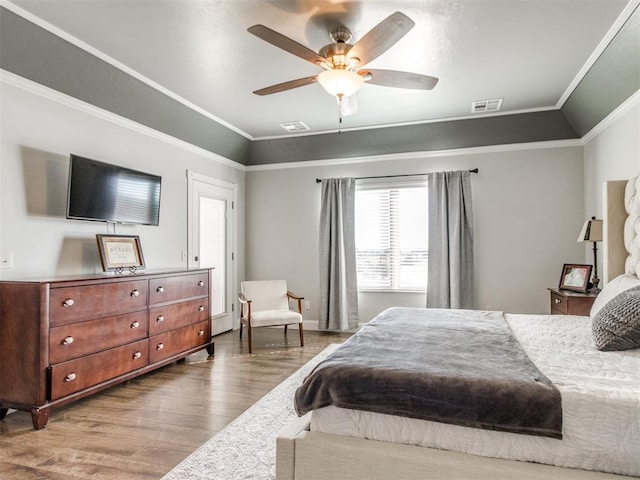 bedroom with ceiling fan, wood-type flooring, lofted ceiling, and crown molding