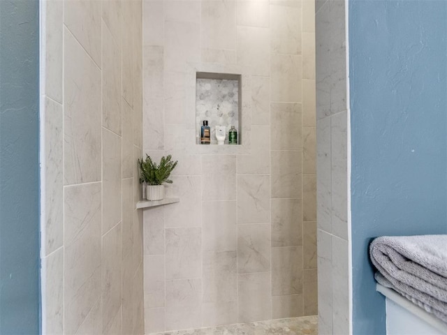 bathroom with a tile shower