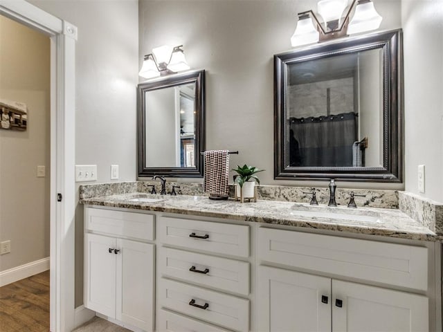 bathroom with hardwood / wood-style floors and vanity