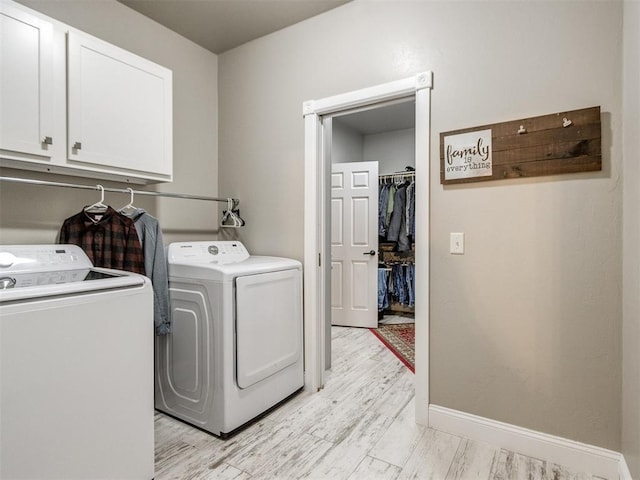 laundry room featuring light wood-type flooring, cabinets, and independent washer and dryer