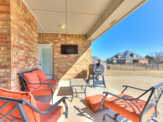 view of patio with an outdoor living space and grilling area