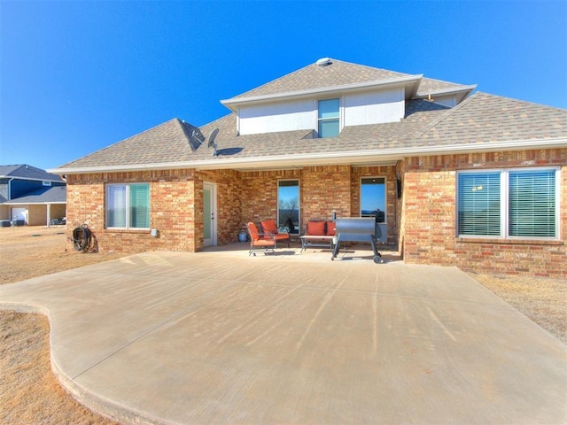 back of house featuring a patio area and outdoor lounge area