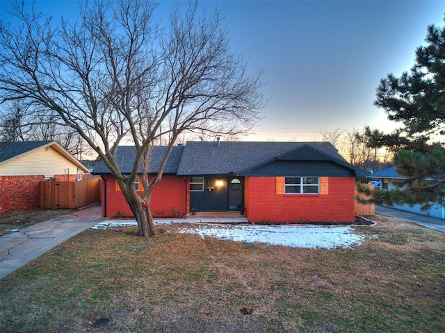 ranch-style home with a lawn