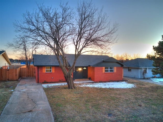 ranch-style home featuring a yard