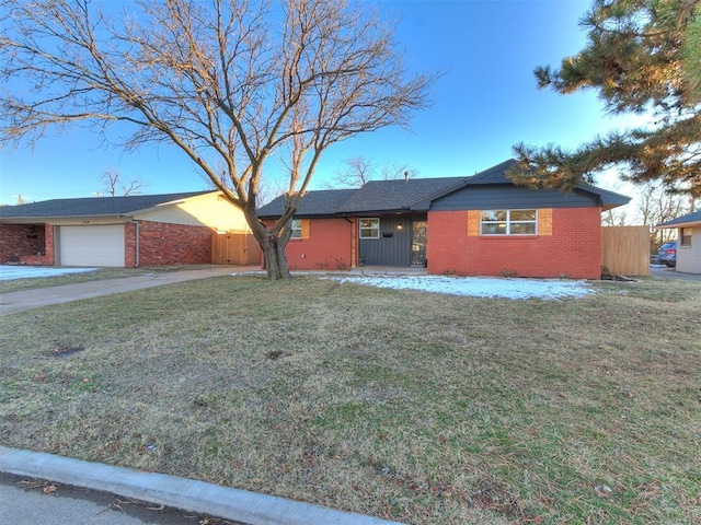 ranch-style home with a garage and a front yard