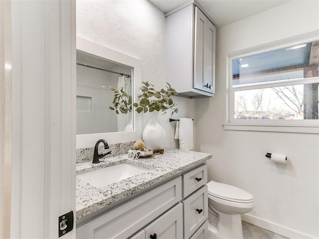 bathroom featuring vanity, a shower with curtain, and toilet