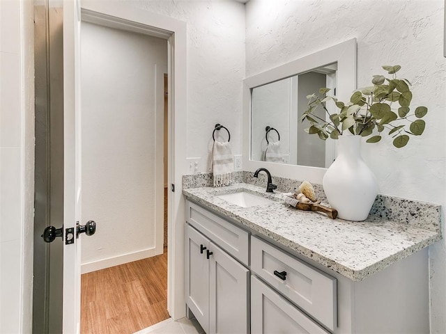 bathroom featuring vanity and wood-type flooring