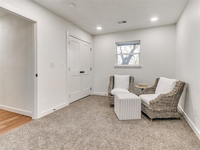 living area featuring carpet